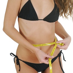Woman measuring waist after liposuction